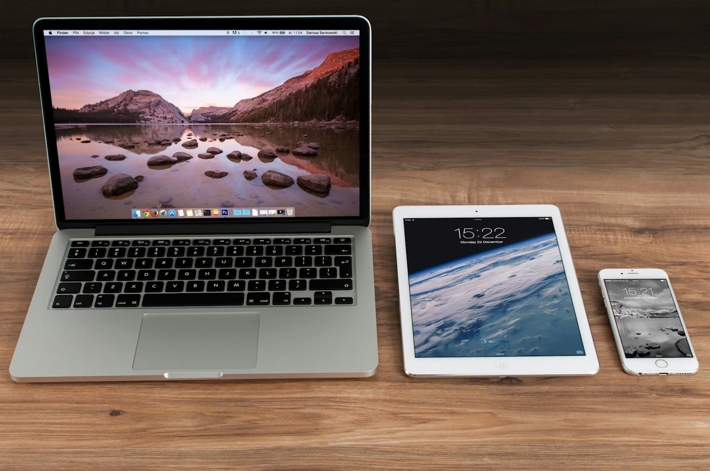 Apple devices on a wooden desk.