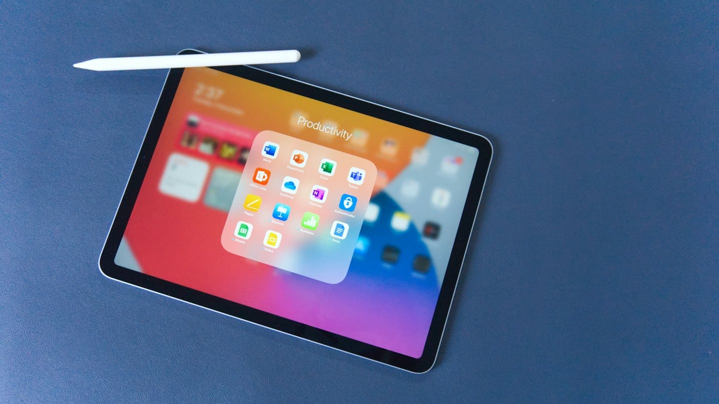 Tablet and stylus display productivity folder on a blue-grey surface.